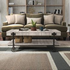 a living room with a couch, coffee table and bookshelf