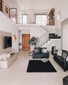 a living room filled with furniture and a stair case