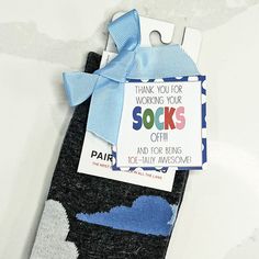 a sock with a blue bow on it and a thank you for working your socks off