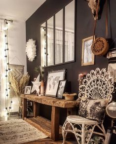 a room filled with furniture and pictures on the wall next to a rug in front of a window