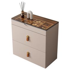 a white dresser with two drawers and candles on top