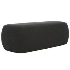 a black speaker sitting on top of a white wall