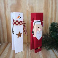 two christmas decorations made to look like santa and snowman