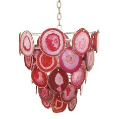 a red and pink chandelier hanging from a metal chain on a white background