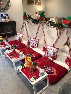 a living room filled with red couches covered in christmas decorations