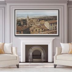 a living room filled with furniture and a fire place in front of a painting on the wall