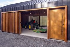 an open garage with two tractors in it