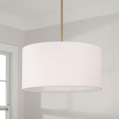 a white lamp hanging from a ceiling in a room