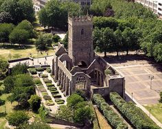 an aerial view of a church in the middle of a park with lots of trees