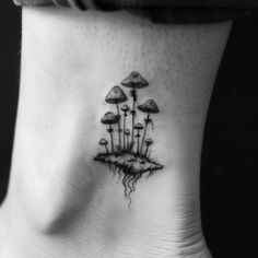 a black and white photo of mushrooms on the side of a woman's neck