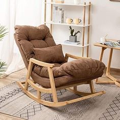 a rocking chair with green cushions in a living room