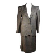 This Yves Saint Laurent skirt suit is composed of a grey plaid wool with blue accents. The jacket has center front button closures. The skirt has a zipper closure. There is a small moth hole, center back. Sold 'As Is' **Please cross-reference measurements for personal accuracy. Measurements (Approximately) Jacket Size 38 Length: 26.5" Sleeve: 23" Shoulder to shoulder: 15.75" Bust: 38" Waist: 36" Hip: 39" Skirt Size 40 (Estimated size, please reference measurements for accuracy) Length: 25.5" Wai Wool Plaid Skirt, Vintage Skirt Suit, Suits Outfits, Skirt Suits, Grey Plaid, Rive Gauche, Gray Plaid, Plaid Skirt, Wool Skirts