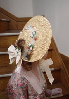 Regency style low crown straw hat with turned up brim in the back, accented with ivory double bow, feather, tulle and small flowers. Satin ribbons are at the sides which can tie under the chin. Spring Curved Brim Boater Hat With Bow, Spring Boater Hat With Bow And Curved Brim, Spring Boater Hat With Curved Brim And Bow, Spring Straw Hat With Bow And Short Brim, Brimmed Boater Hat With Bow For Kentucky Derby, Short Brim Boater Hat With Bow For Garden Party, Elegant Spring Straw Hat With Bow, Elegant Adjustable Bonnet For Summer, Elegant Adjustable Summer Bonnet