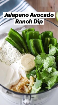 a food processor filled with green vegetables and other ingredients to make ranch dip in the blender