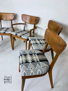 three mid century style chairs and footstools in the shape of an arm chair