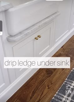 a white sink sitting under a faucet next to a counter top in a bathroom