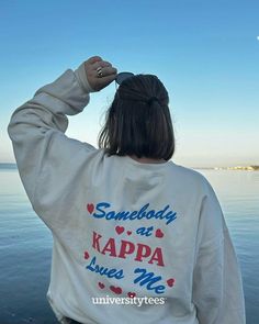 the back of a woman's sweatshirt that says somebody at kappa hugs me