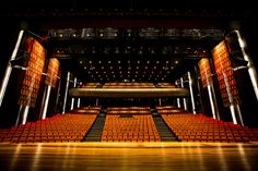 an empty auditorium with rows of seats and lights