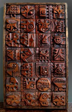 a wooden box with many different designs on it