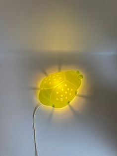 a yellow lamp that is on the wall