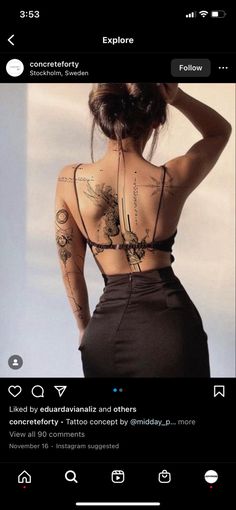 the back of a woman's body with tattoos on it