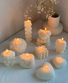 some candles are sitting on a white table