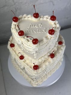 a heart shaped cake with cherries on top