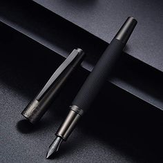 a pen sitting on top of a black table