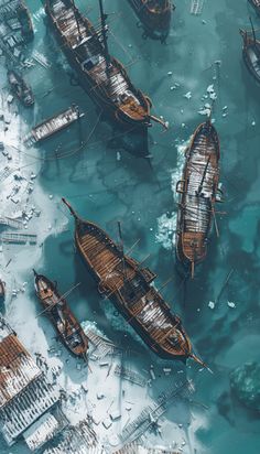 an aerial view of several boats floating in the water with ice around them and snow on the ground