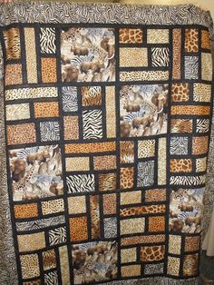 an animal themed quilt on display in a room