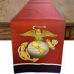 a red table runner with an eagle, globe and anchor on the front is shown