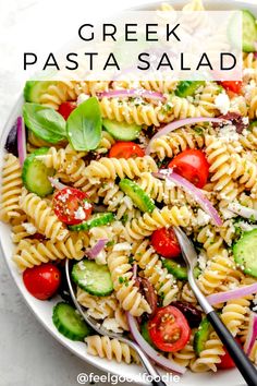 a white bowl filled with pasta salad on top of a table