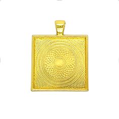 a gold square pendant with an intricate design on the front and back side, set against a white background