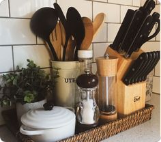 kitchen utensils and cooking utensils in a wicker basket on the counter