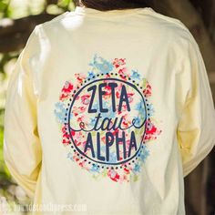 the back of a woman's shirt that says, zeta ya aloha