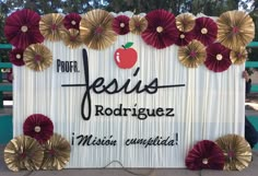 a sign with paper flowers and an apple on it that says jesus rodriquez