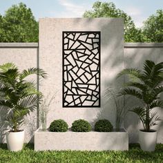 a white wall with some plants and potted plants in it next to a fence