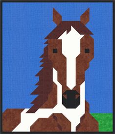 a brown and white horse sitting on top of a green field next to a blue sky