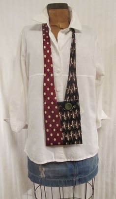 a white shirt and red tie are on a mannequin headpieces stand