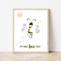 a poster with the words, my first bee day on it in front of a white wall