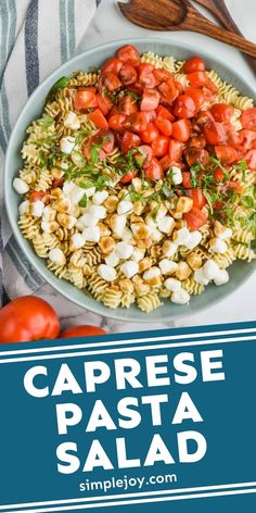 caprese pasta salad with tomatoes and onions in a bowl