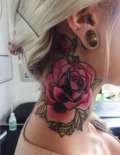 a woman's neck with a rose tattoo on the top and bottom of her neck