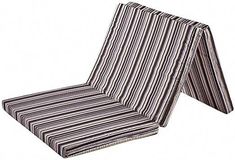 an outdoor chair cushion with black and white stripes on the seat, folded up to show the pattern