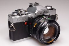 an old camera sitting on top of a white table