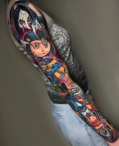 a man's arm with an anime character tattoo on it and other characters around the arm