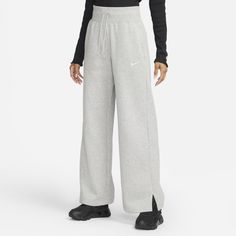 Rise up and transform your fleece wardrobe with strong cozy vibes. The extra-long, wide leg and hem vents of these Phoenix Fleece pants let you show off your favorite shoes while taller ribbing at the waist and an exaggerated drawcord ensure your look is anything but basic. Benefits Smooth on the outside and cozy on the inside, brushed fleece is our go-to sweatshirt material for colder temperatures. Elongated ribbing at the waist provides extra comfort and structure. Product Details Body: 80% co Nike Sportswear Phoenix Fleece, High Waisted Sweatpants, Fleece Pants Women, High Waisted Wide Leg Pants, Nike High, Wide Leg Sweatpants, Nike Sweatpants, Loungewear Luxury, Nike Leggings