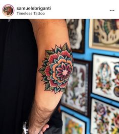 a man with a flower tattoo on his arm