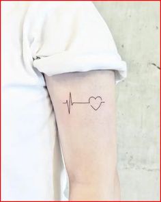 a small heartbeat tattoo on the arm