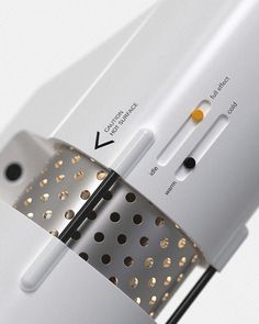 an electronic device with gold dots on the side and black dots on the back of it