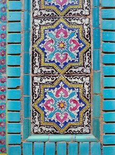 an ornate blue and white tile design on the side of a building